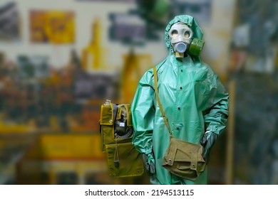 Man Wearing Gas Mask  And Radiation Protection Suit Standing Infront Of Factory. Background Out Of Focus