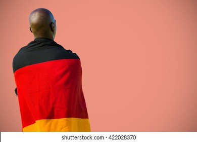 Man wearing German flag against orange background - Shutterstock ID 422028370