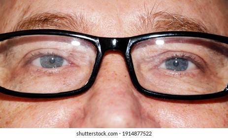 A Man Wearing Glasses Reading, A Photo Close Up