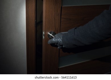 Man Wearing Gloves Opens The Door At Night