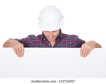 Man Wearing Hard Hat Holding Placard On White Background