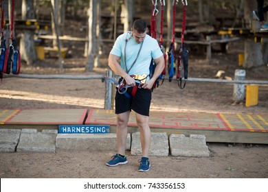 Man Wearing Harness In Park On A Sunny Day