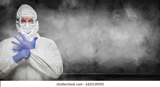 Man Wearing Hazmat Suit and Goggles In Smokey Room Banner with Copy Space.