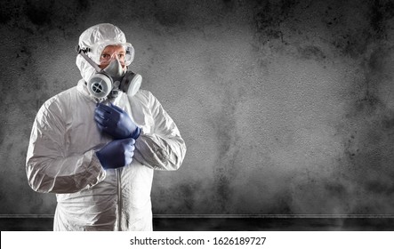 Man Wearing Hazmat Suit, Protective Gas Mask and Goggles Against Dark Wall.