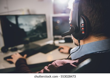 Man wearing headphones and playing video game - Powered by Shutterstock