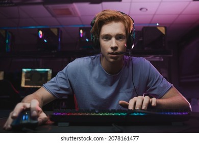 Man wearing headset sitting in front of the computer and being involved at the game - Powered by Shutterstock