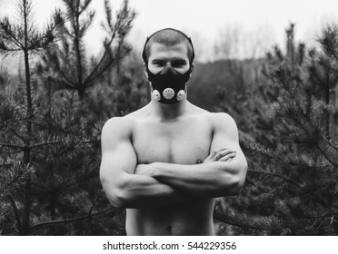 Man Wearing High Altitude Mask Fitness Training. Black And White Photo
