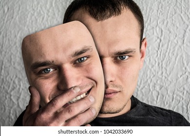 A man wearing a hilarious mask of the deceiver - Shutterstock ID 1042033690
