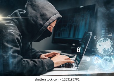 Man Wearing Hoodie And Mask Hacking Personal Information On A Computer In A Dark Office Room With Digital Background. Cyber Crime, Deep Web And Ransomware Concept.
