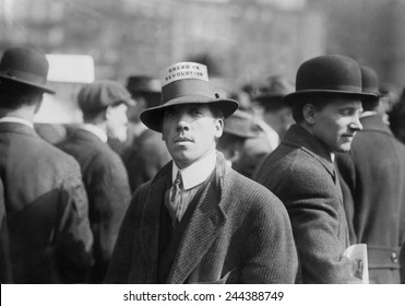 Man wearing a Industrial Workers of the World Hat Card reading 'Bread or Revolution' in a rally at New York City's Union Square. Ca. 1914.
