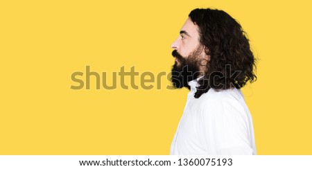 Man wearing Jesus Christ costume looking to side, relax profile pose with natural face with confident smile.