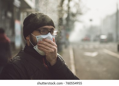 A man wearing a mask on the street. Protection against virus and grip