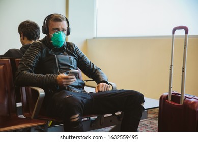 Man Wearing A Mask Protection At An Airport. Epidemic Corona Virus Infection, Flu Sickness And Travel Illness Concept