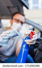 Man Wearing Medical Mask And Cleaning Car Air Duct With Microfiber Cloth And Spray Bottle Disinfectant.