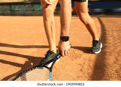 Man wearing modern smart watch during training on tennis court, closeup - Powered by Shutterstock