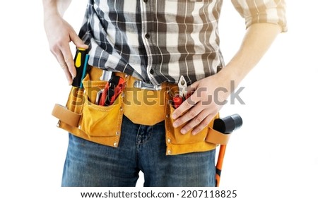 Man wearing mounting belt with tools for repair isolated on white background. Professional equipment of handyman