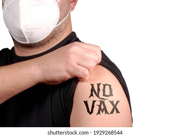 Man Wearing Protective Mask Protests Against New Covid-19 Vaccine Showing Tattoo No Vax On His Arm. Anti Vax Person Rejecting Syringe With Anti Covid Vaccine. Freedom Of Choice About Own Health