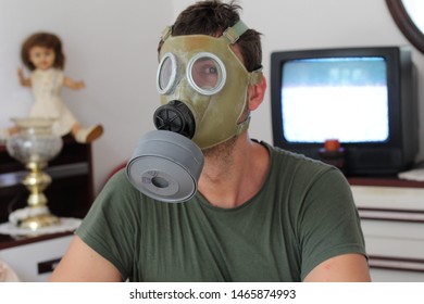 Man Wearing Retro Gas Mask At Home