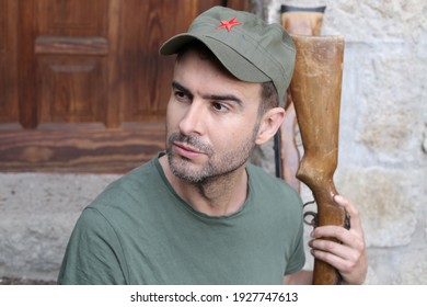 Man Wearing Revolutionary Green Hat With Red Star