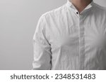 Man wearing rumpled shirt on white background, closeup