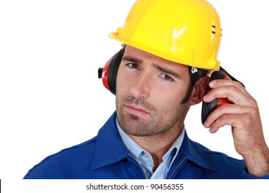 Man Wearing Safety Earmuffs And Helmet