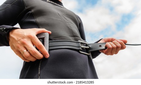 Man Wearing Scuba Diving Weights Before Going Underwater