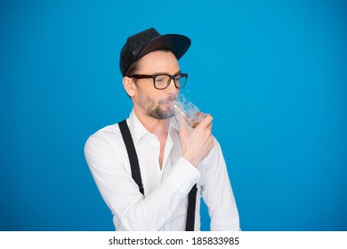 man wearing shirt and hat smoking e-pipe wearing hat