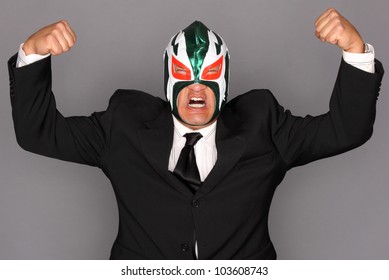 Man Wearing A Suit And Luchador Mask.