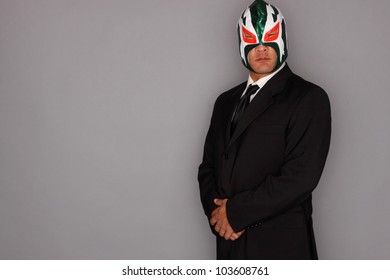 Man Wearing A Suit And Luchador Mask.