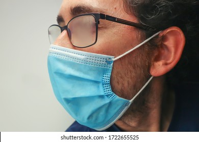 Man Wearing Surgical Mask And Fogged Glasses