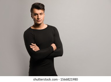 Man wearing thermal underwear on grey background. Space for text