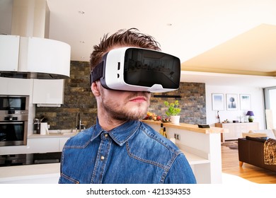 Man wearing virtual reality goggles. Home interior. VR glasses. 360 degrees. Virtual reality headset. VR game. Wearing virtual reality goggles. Smartphone with VR. Virtual reality video. - Powered by Shutterstock