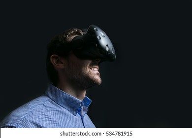 Man Wearing Virtual Reality Goggles. Low Key Photo