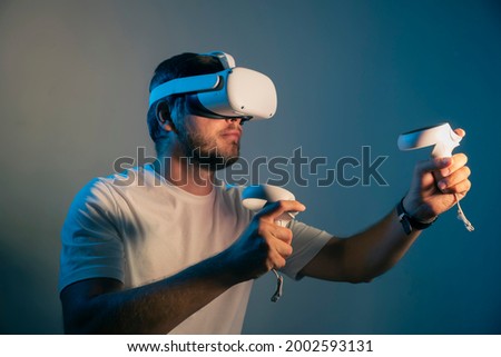 man wearing Virtual Reality   VR Headset. VR for gaming. Man play game in VR glasses. Hipster with virtual reality headset.