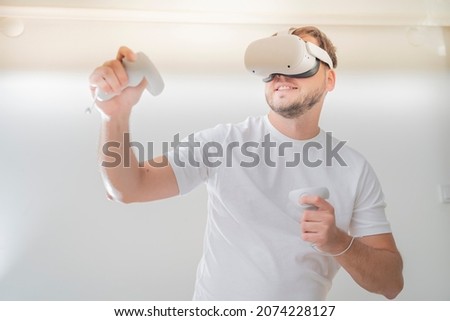 man wearing Virtual Reality VR Headset. VR for gaming. Man play game in VR glasses