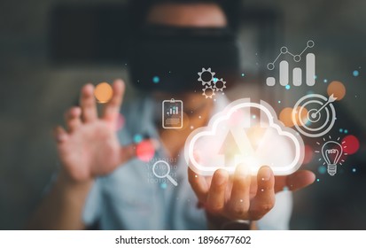 man wearing VR glasses and accessing the Cloud Computing Technology Internet Storage Network Concept And a large database big data Through internet technology.