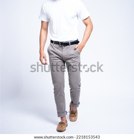 Man wearing white basic t shirt and grey chino pants catalogue