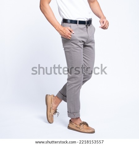 Man wearing white basic t shirt and grey chino pants catalogue