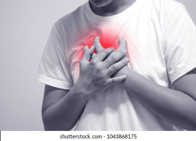 A man wearing a white shirt with heart ache.