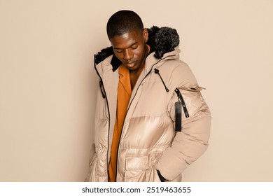 Man wearing a winter outfit. Handsome African American young man. African American man wearing a winter jacket. Winter fashion concept, warm men's clothing. - Powered by Shutterstock