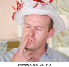 Man wearing a woman's hat. - Shutterstock ID 28341466