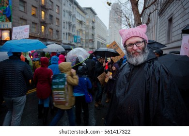 A man wears a pink knitted hat with cat ears at the Women's March in San Francisco to protest the inauguration of Donald Trump - Jan. 21, 2017