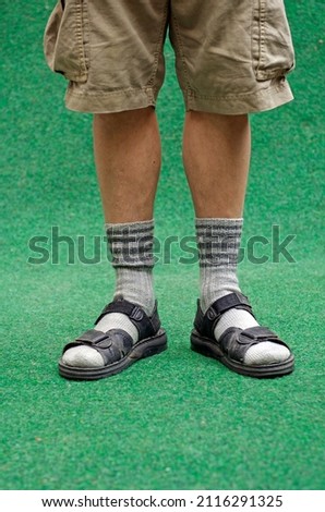 Man wears socks in sandals