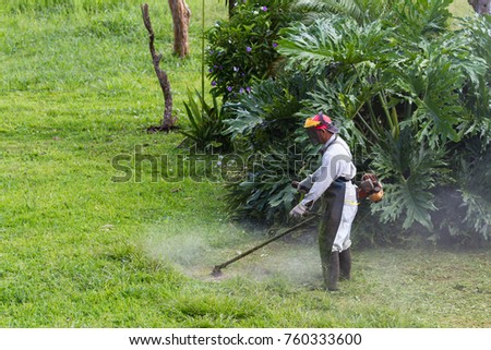 Similar – Young man mowing the lawn with lawnmower