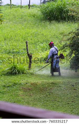 Similar – Young man mowing the lawn with lawnmower