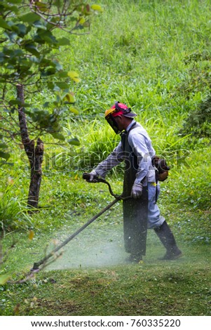 Similar – Young man mowing the lawn with lawnmower