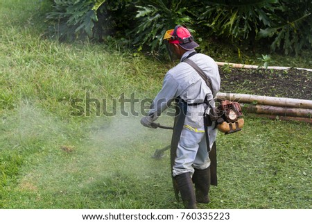 Similar – Young man mowing the lawn with lawnmower