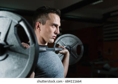 Man With Weight Training Equipment On Sport Gym Club