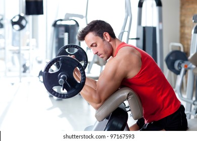 Man With Weight Training Equipment On Sport Gym Club