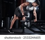 Man, weightlifting and dumbbell as bodybuilder or athlete in sports practice, training and gym. Male person, equipment and routine for challenge, muscle and wellness in workout, fitness and exercise